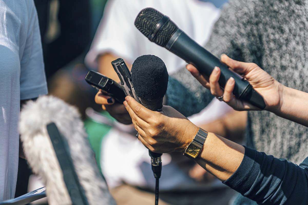 journalists holding microphones 