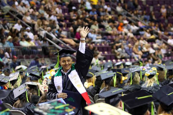 ppsc student at commencement ceremony waving to crowd
