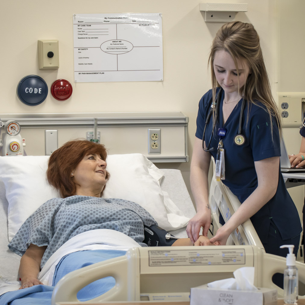 Nursing student taking patient blood pressure