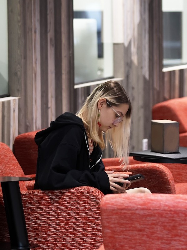 student sitting in chair reading