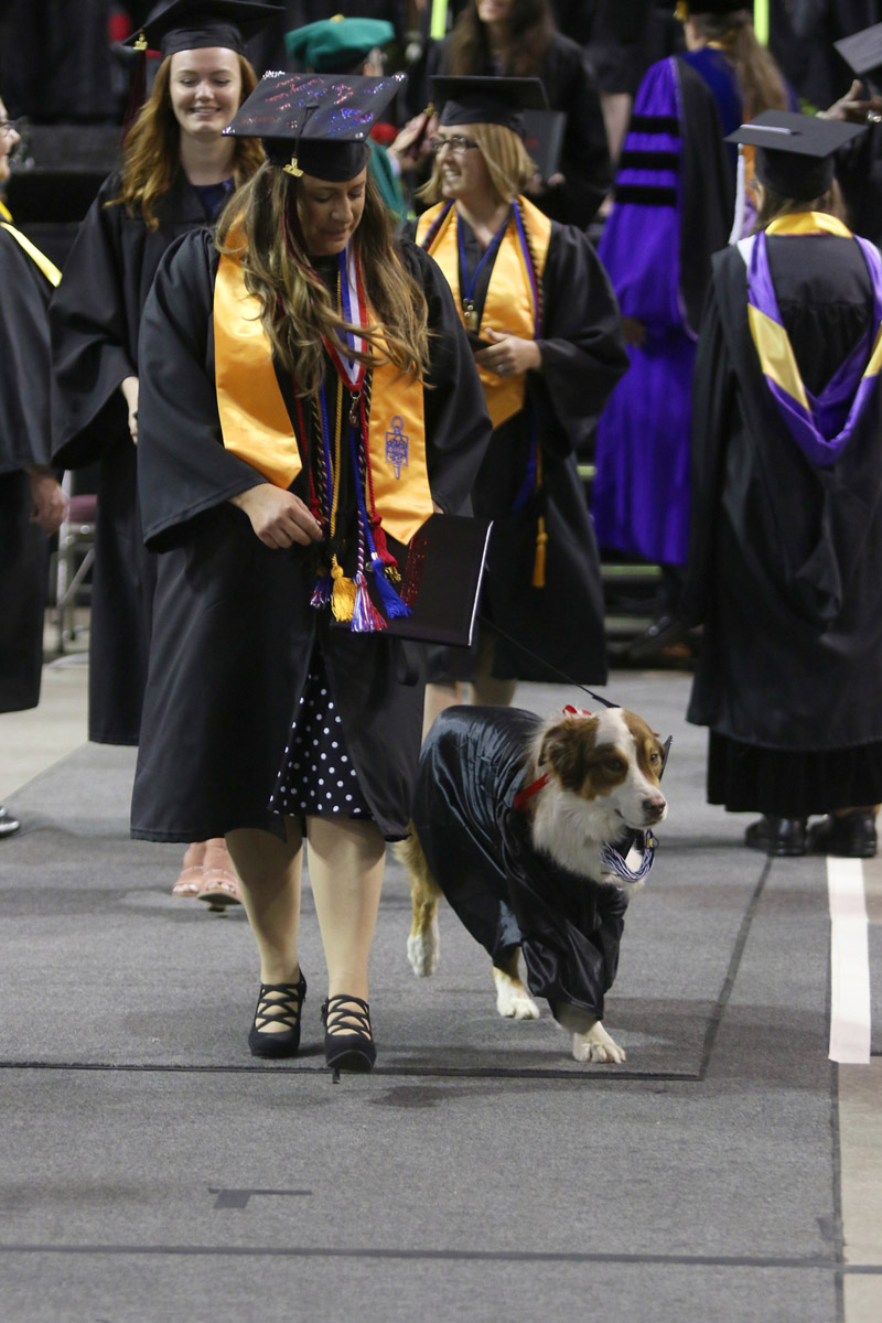 Woman with dog at commencement ceremony