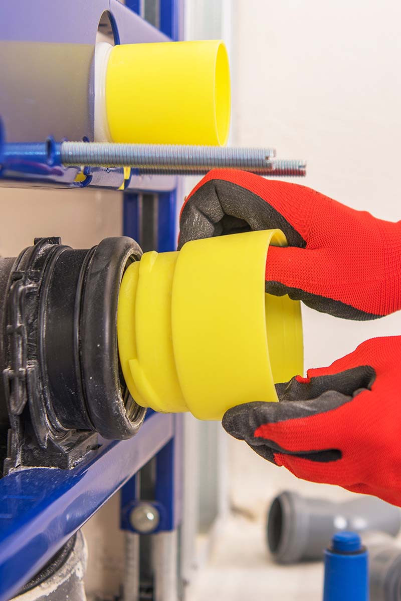 studnet hands working on plumbing