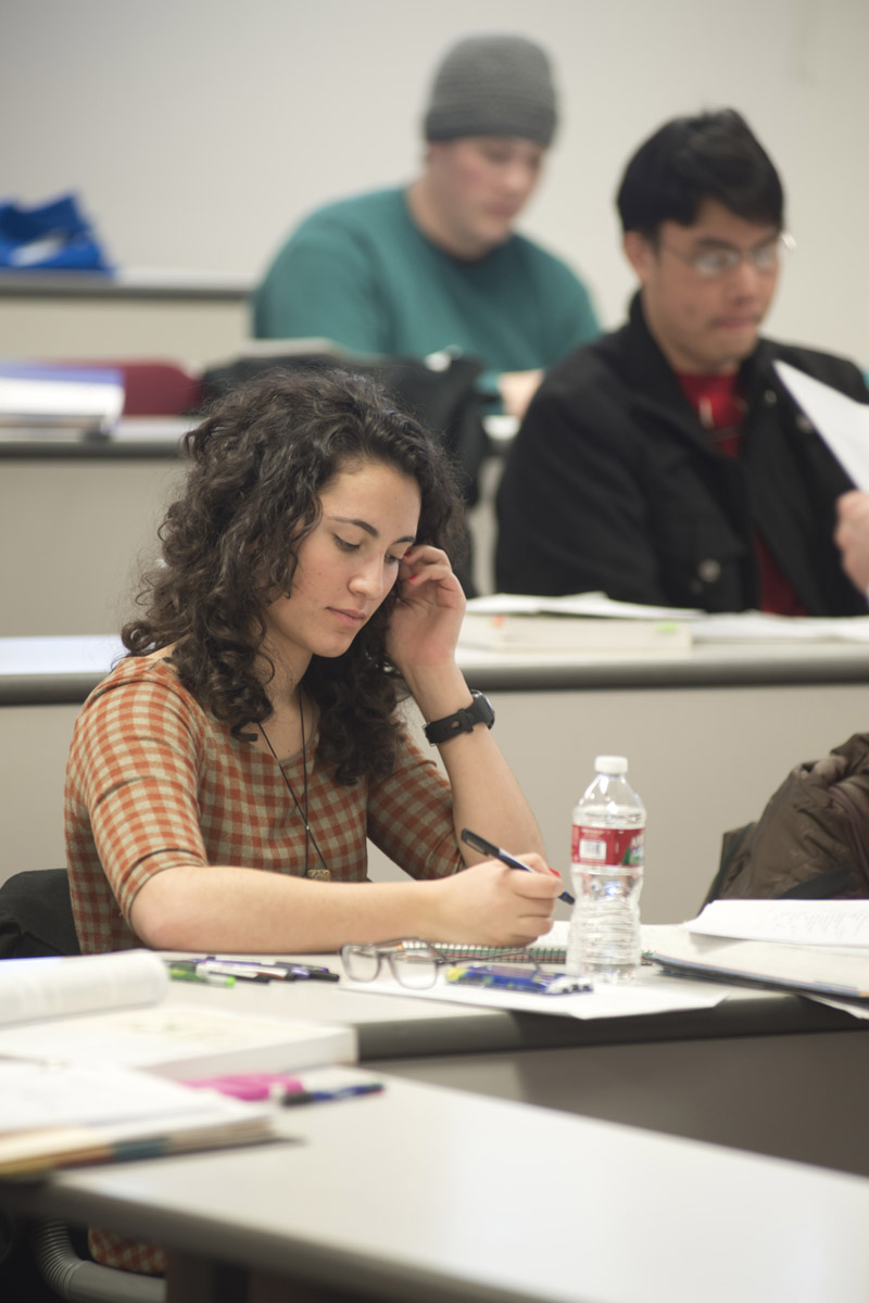 A student focusing on notes