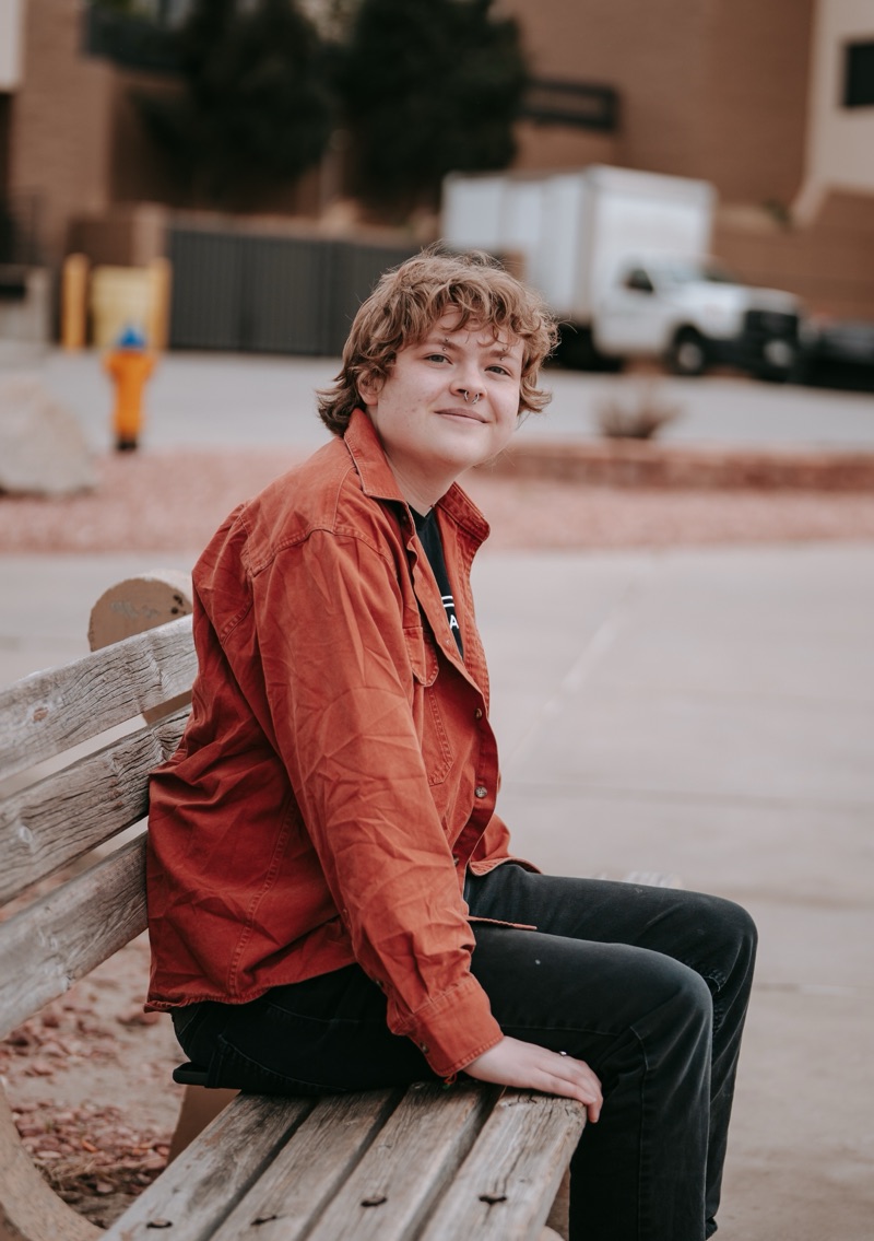 Smiling PPSC student sitting on a bench outdoors