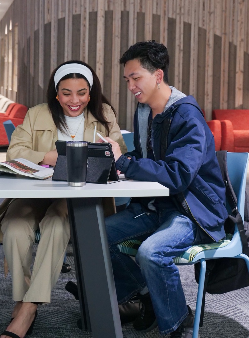 Two PPSC students looking at a tablet together